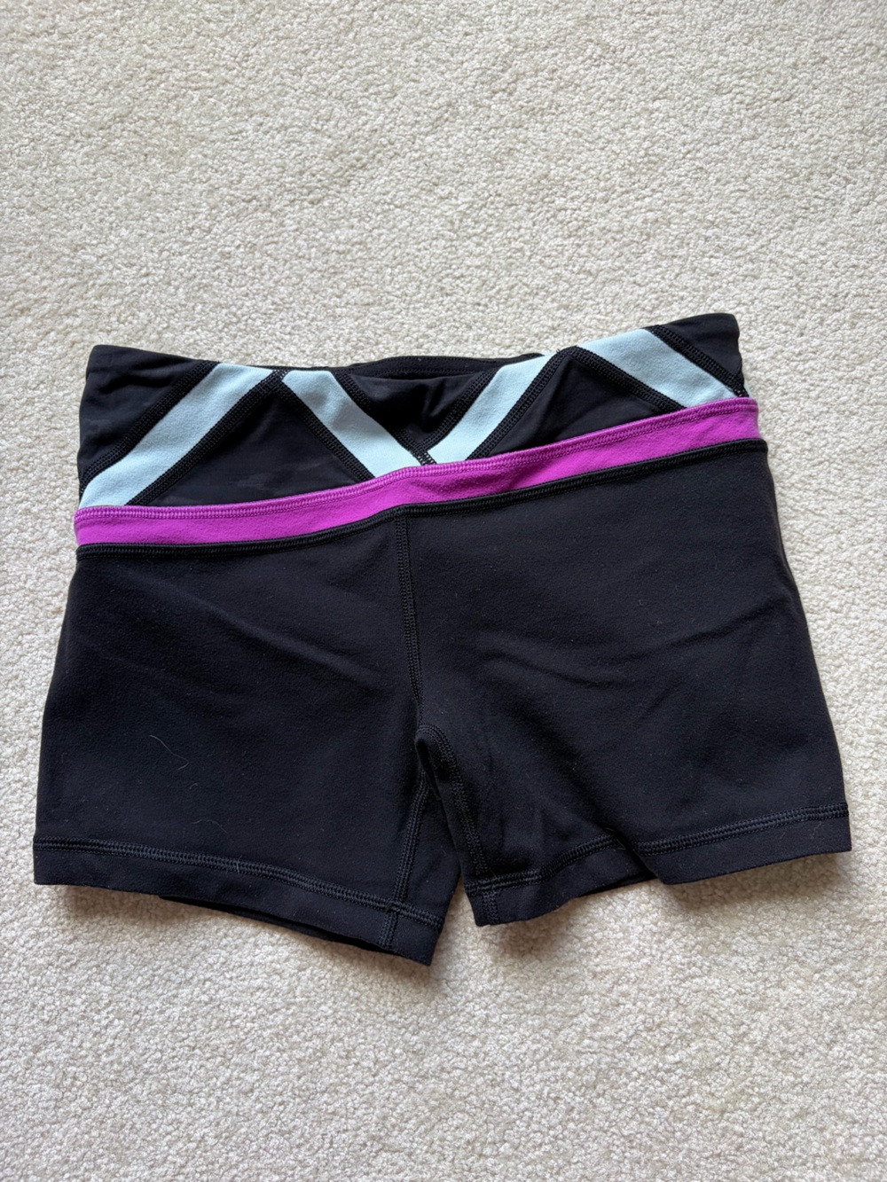 Ivivva Children’s black and multi pattern workout shorts.